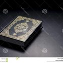 Islamic Holy Book Quran Under Soft Light Black Background